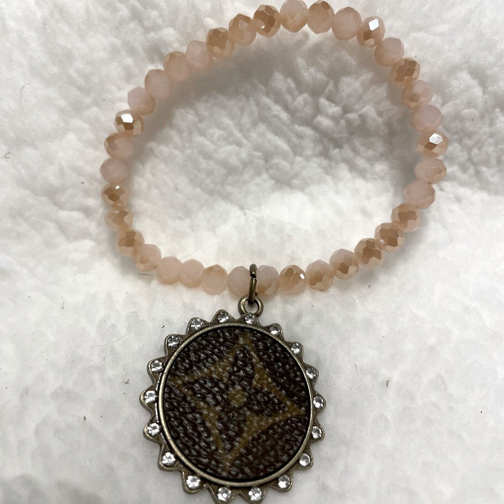 Cream beaded, stretch bracelet with upcycle charm. New, never worn.